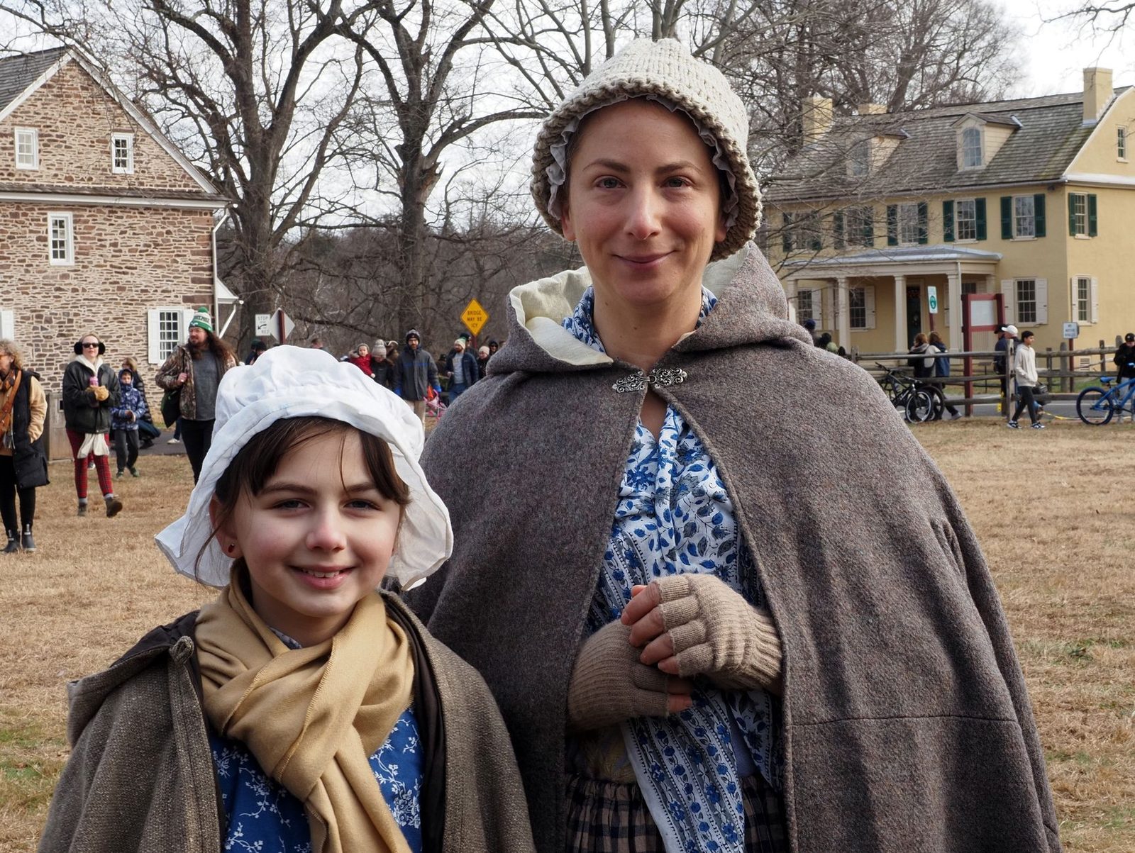 Two women in colonial attire during a reenactment event in Washington Crossing.