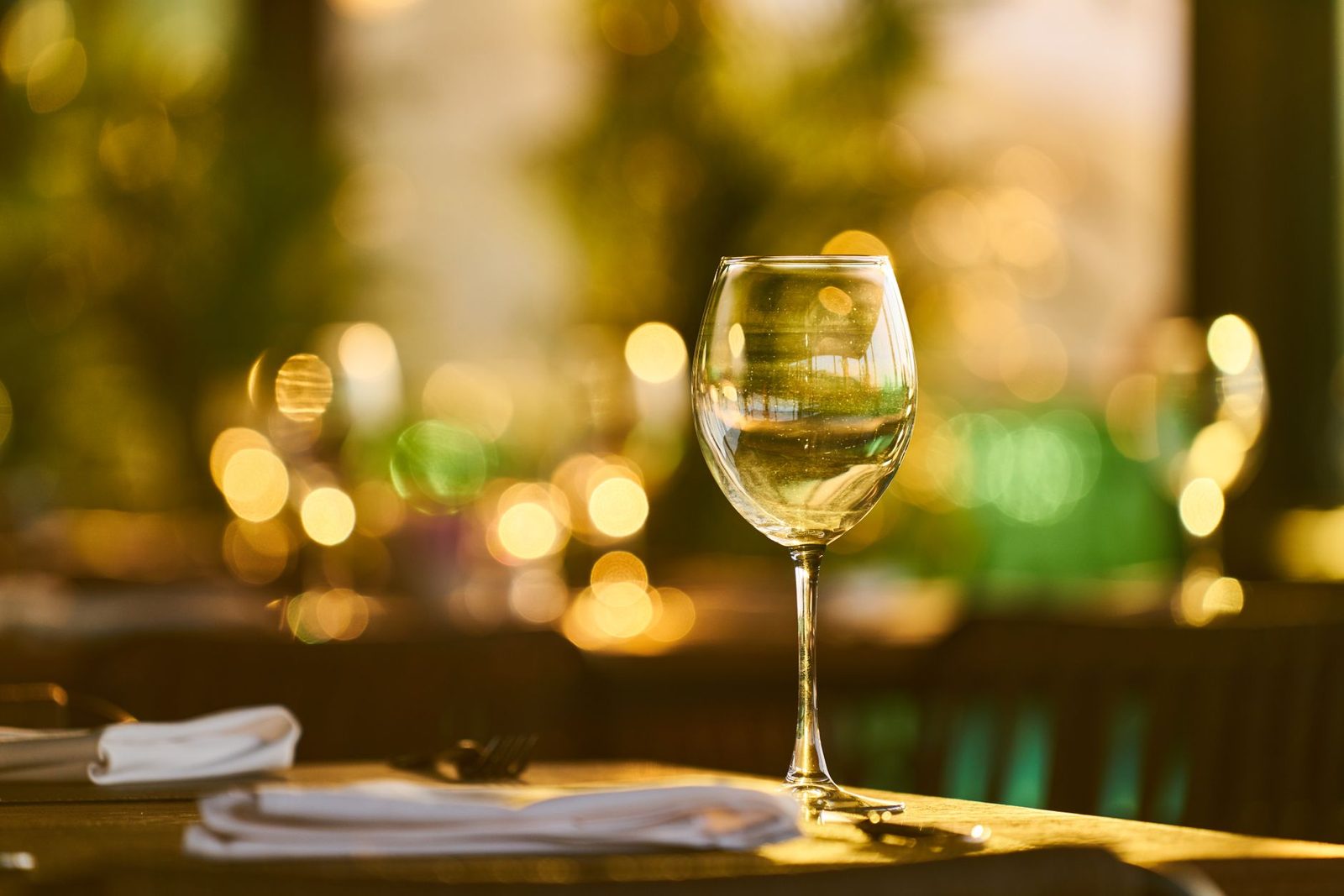 A sparkling wine glass with bokeh lights in a cozy indoor setting, perfect for celebrations.